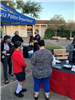 Residents and City staff get breakfast from a Chik-fil-A table in the City Hall courtyard
