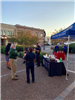 Police and residents mingle near a Victoria Police Department booth in the City Hall courtyard.