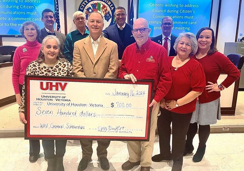 Group photo with a giant check at Council chambers