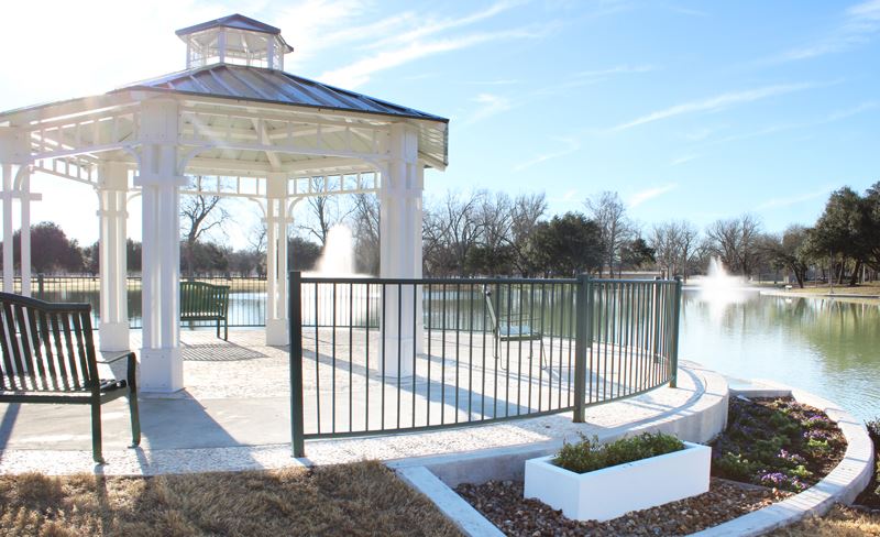 Duck pond gazebo surrounded by planter boxes with purple flowers