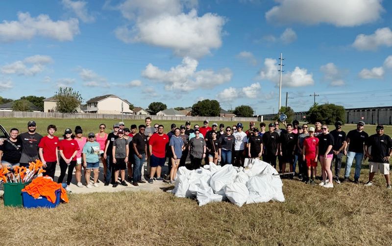Large group of people with bags of collected trash