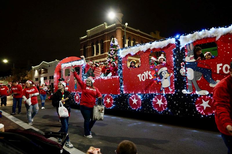 Toys for Tots float decorated as a train with Bluey and Bugs Bunny on the side.