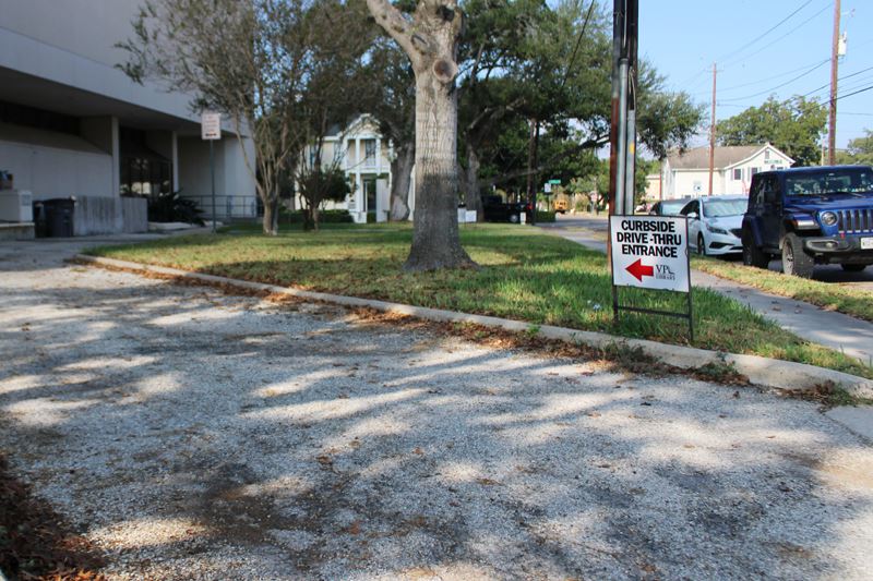 Victoria Public Library curbside drive thru with visibly distressed pavement.