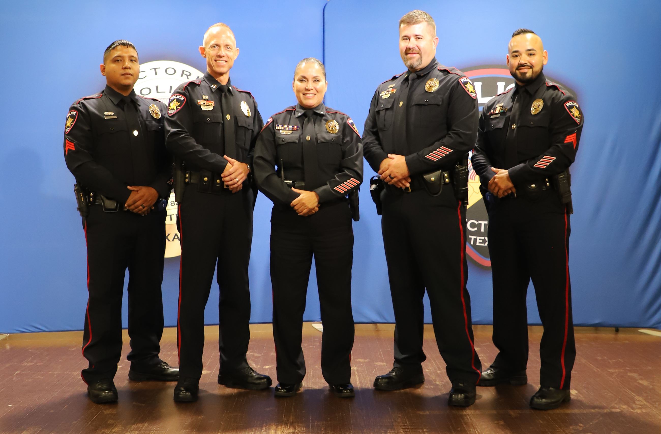 Group photo of five uniformed police officers Opens in new window