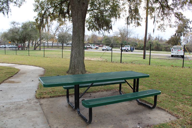 A bench with a longer surface on one side for wheelchair access.
