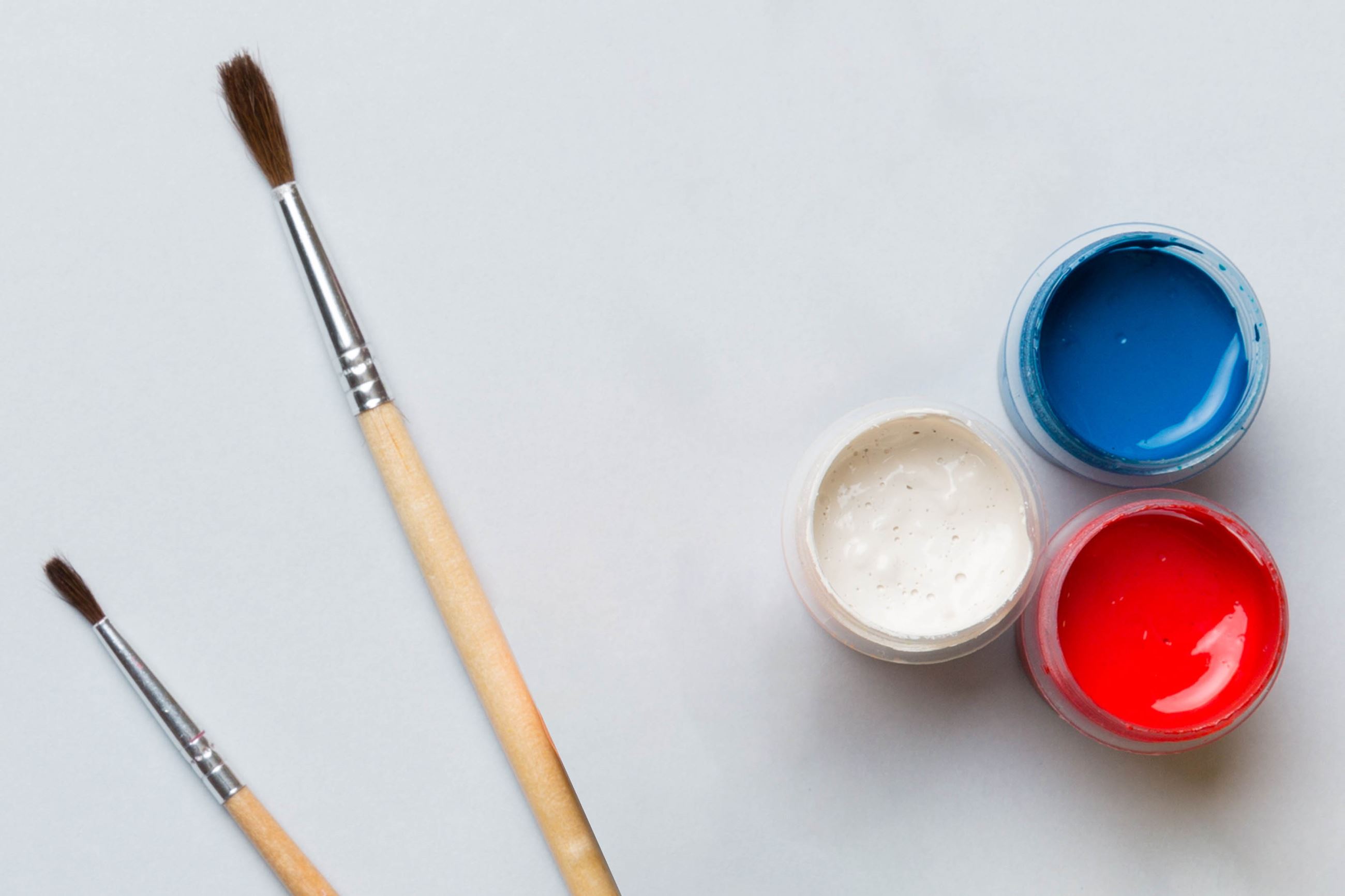 A paint brush with Red, White, and Blue paint